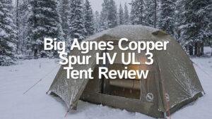 Big Agnes Copper Spur HV UL 3 tent pitched in a winter forest campsite.