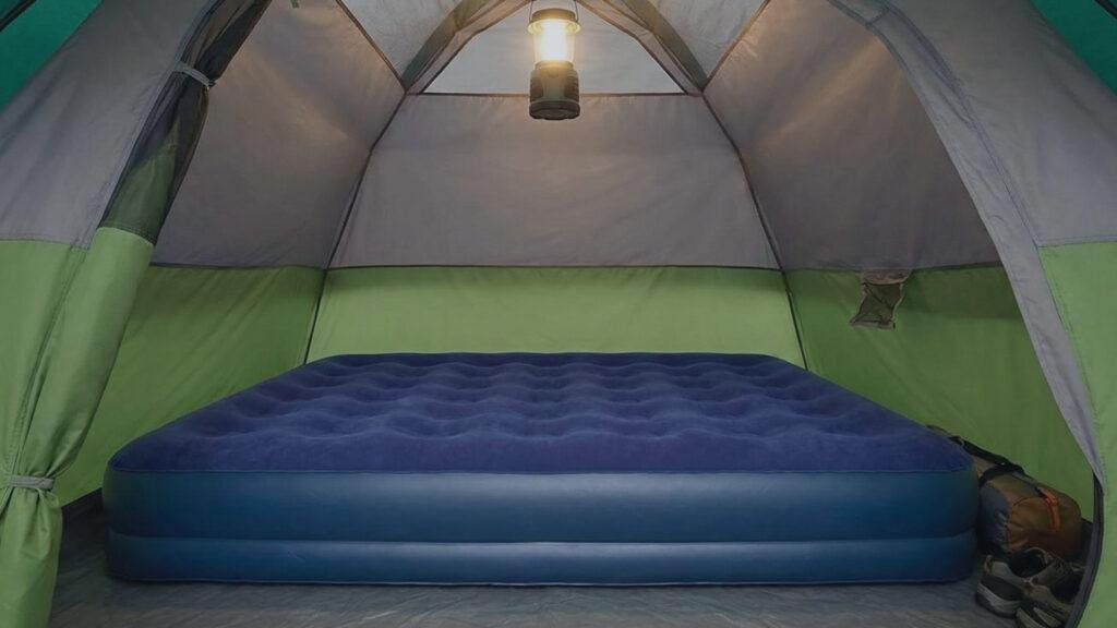 Interior of Coleman Sundome 4 showing a queen air mattress filling the space.