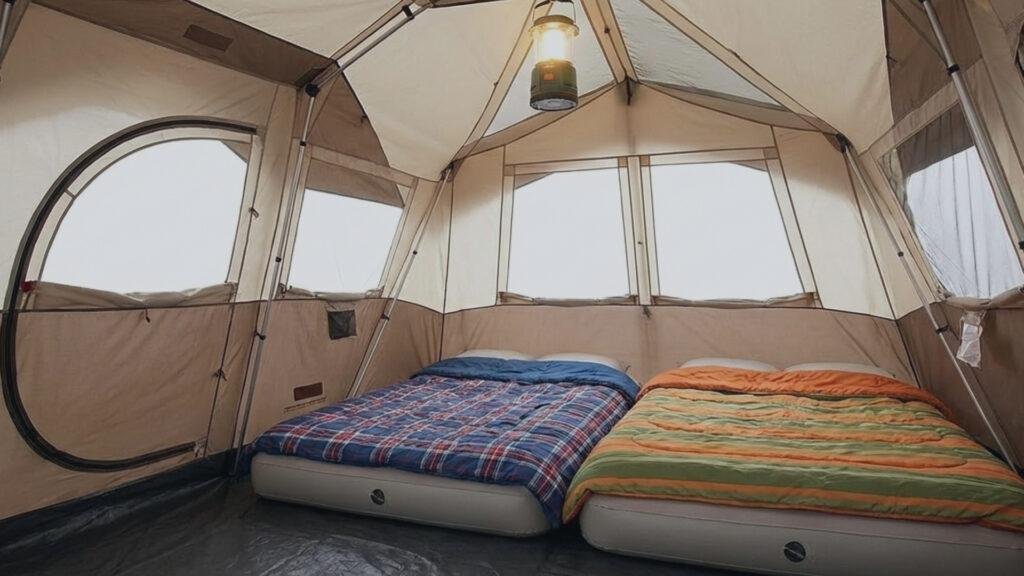 Interior view showing two queen air mattresses inside the Coleman WeatherMaster 6 tent with Screen Room