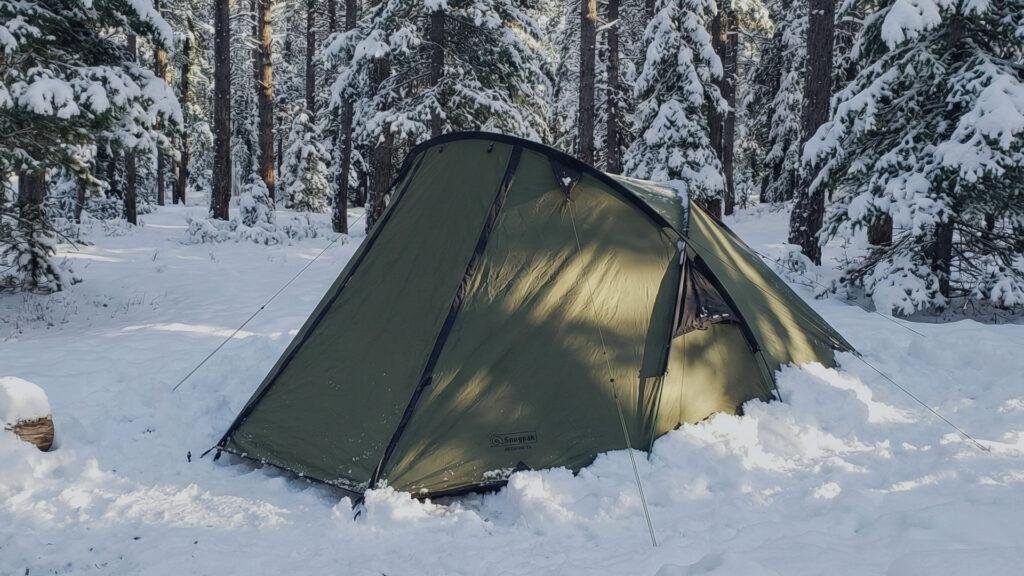 Snugpak Scorpion 3 tent pitched in a winter forest campsite