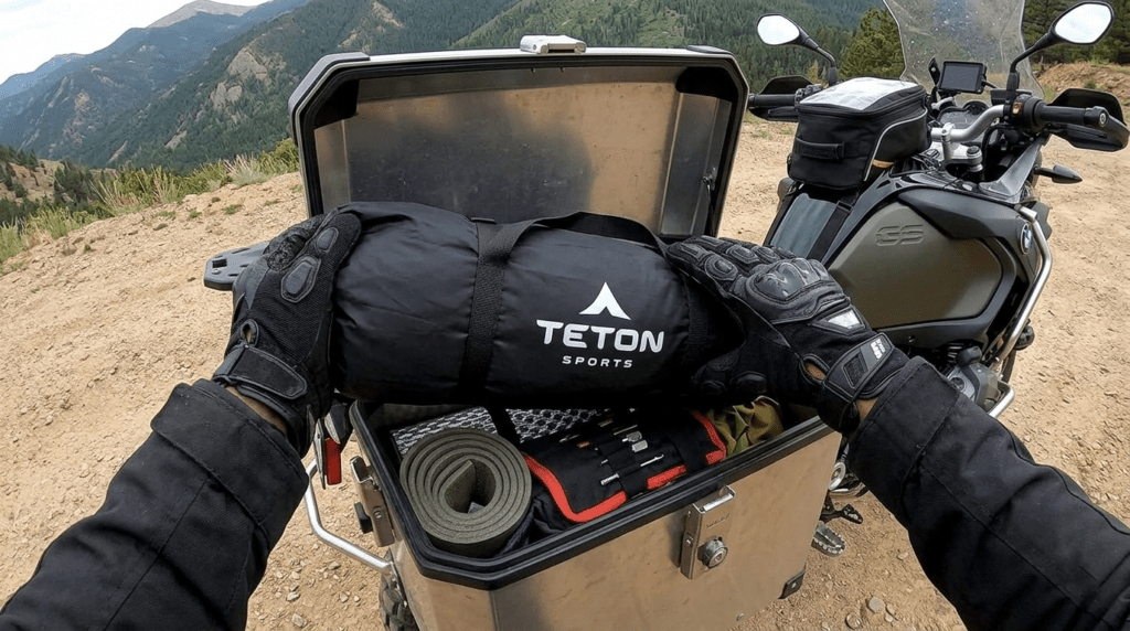 Packing TETON Sports Mountain Ultra 2 tent into a motorcycle pannier showing its compact 16-inch pack size.