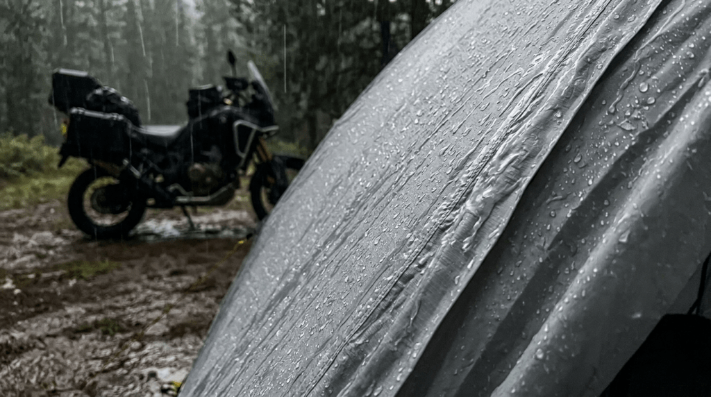 Rain beading on the waterproof rainfly of a TETON Sports Mountain Ultra 2 tent during a motorcycle camping trip.