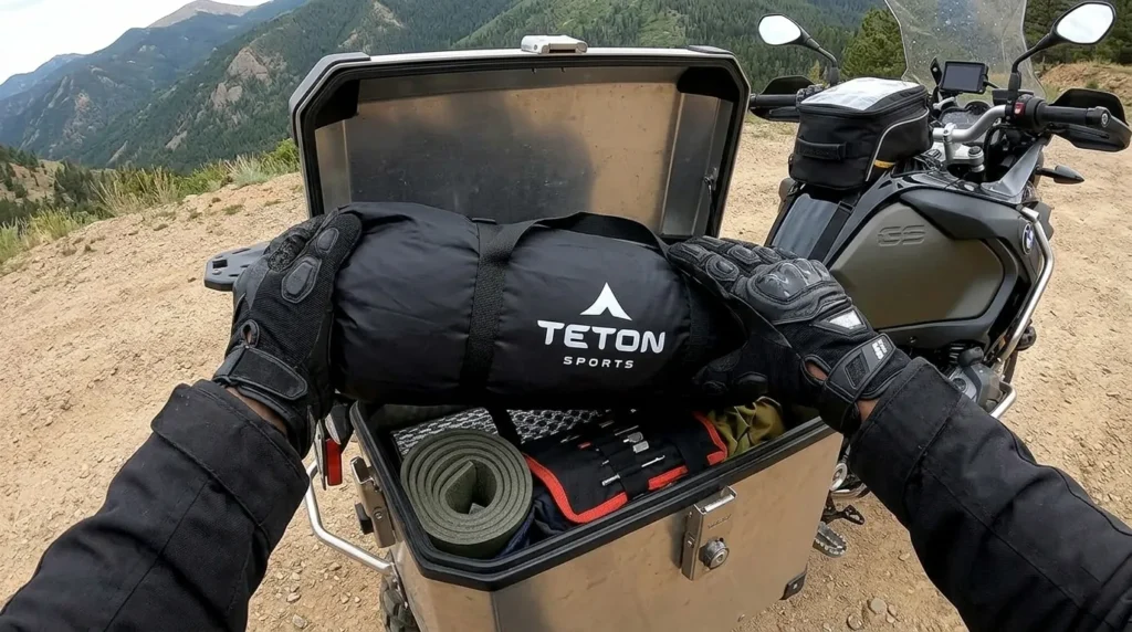Packing TETON Sports Mountain Ultra 2 tent into a motorcycle pannier showing its compact 16-inch pack size.