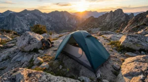 ALPS Mountaineering Lynx 1 tent pitched on a mountain at sunset.