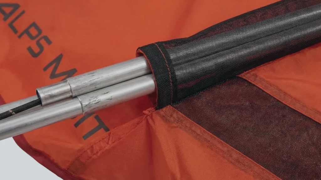 Close up view of the aluminum poles sliding into continuous sleeves on the ALPS Mountaineering Tasmanian 2 tent.