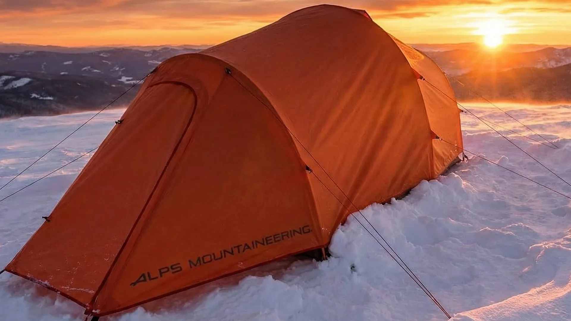 ALPS Mountaineering Tasmanian 2 tent pitched on snow during a winter sunset.