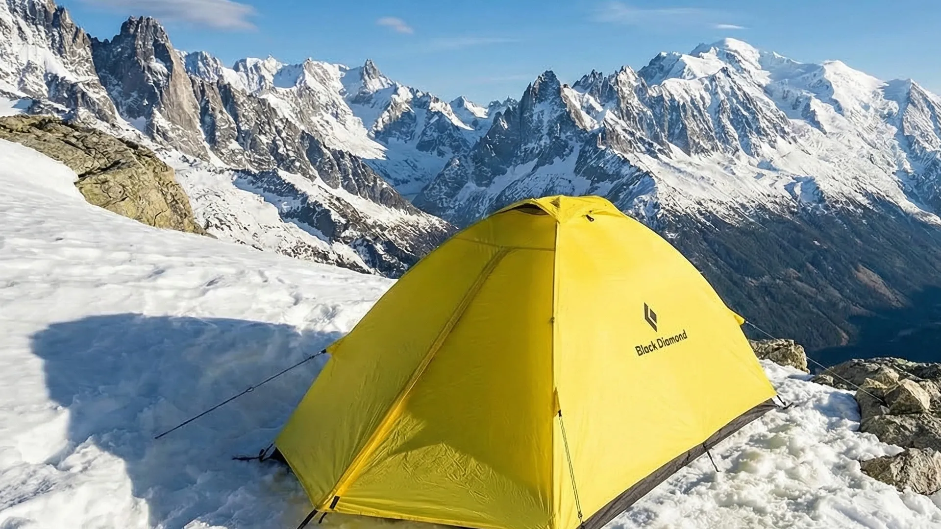 Black Diamond Eldorado yellow mountaineering tent pitched in snow on a high altitude ridge.