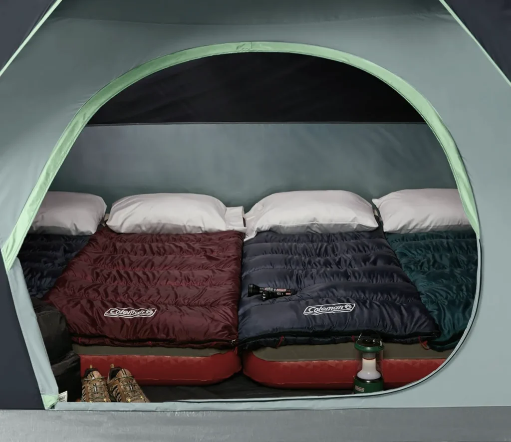 Space inside the Coleman Skydome 6 person tent showing 4 single mattress.