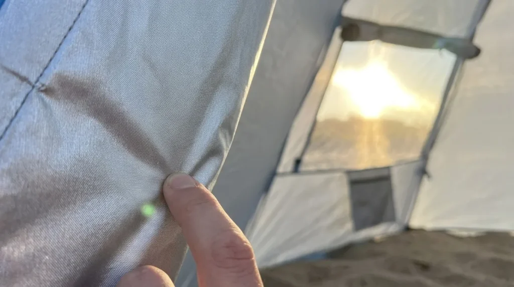 A close up view of the silver anti-UV coating on the interior of an Oileus pop up tent.