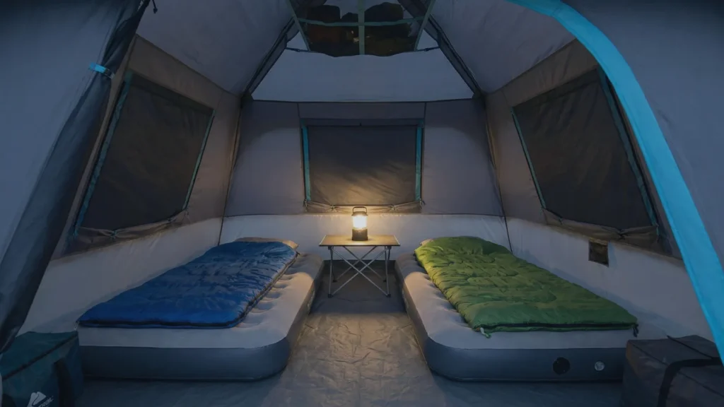 Interior view of Ozark Trail 6 Person Tent with two air mattresses and gear.
