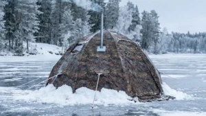 Russian Bear Hot Tent pitched on a frozen lake with a wood stove burning inside.