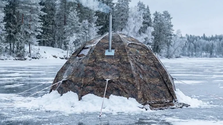 Russian Bear Hot Tent pitched on a frozen lake with a wood stove burning inside.
