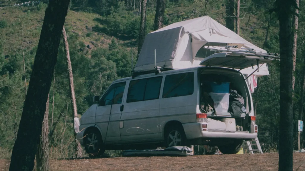 An RV site tent camping photo showing the the setup, a camping tent on top of the car.