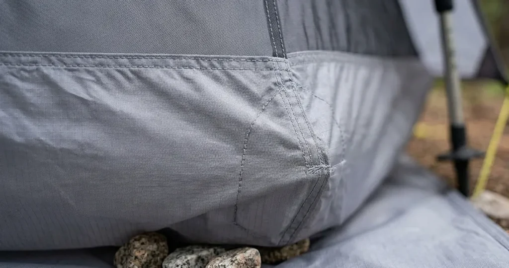 Detailed view of the 20D sil poly fabric and reinforced corner stitching on a Six Moon Designs Lunar Solo.