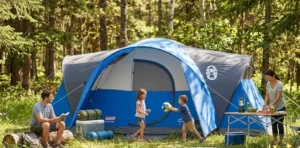 A Coleman Montana 8 person tent fully set up at a forest campsite.