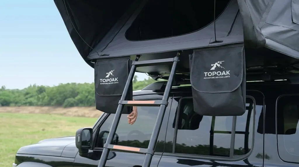 The 90.5 inch telescopic ladder extended to a Topoak Vision rooftop tent on a lifted vehicle.