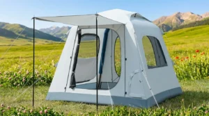 An Fseoot automatic inflatable tent fully set up in a meadow using its one-button pump.