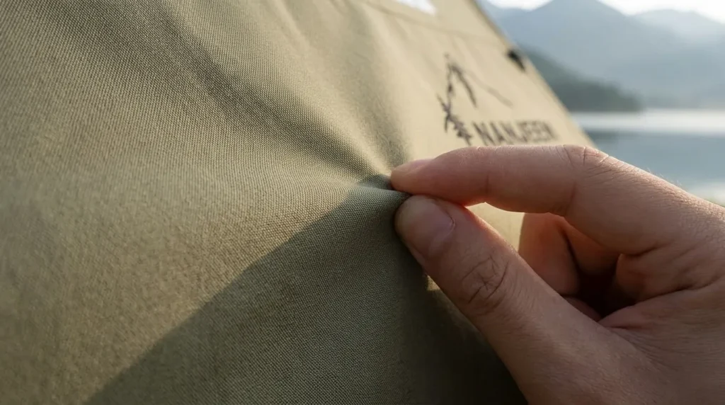 A close up view of the breathable tech-cotton fabric on a NANJEEN luxury inflatable camping tent.