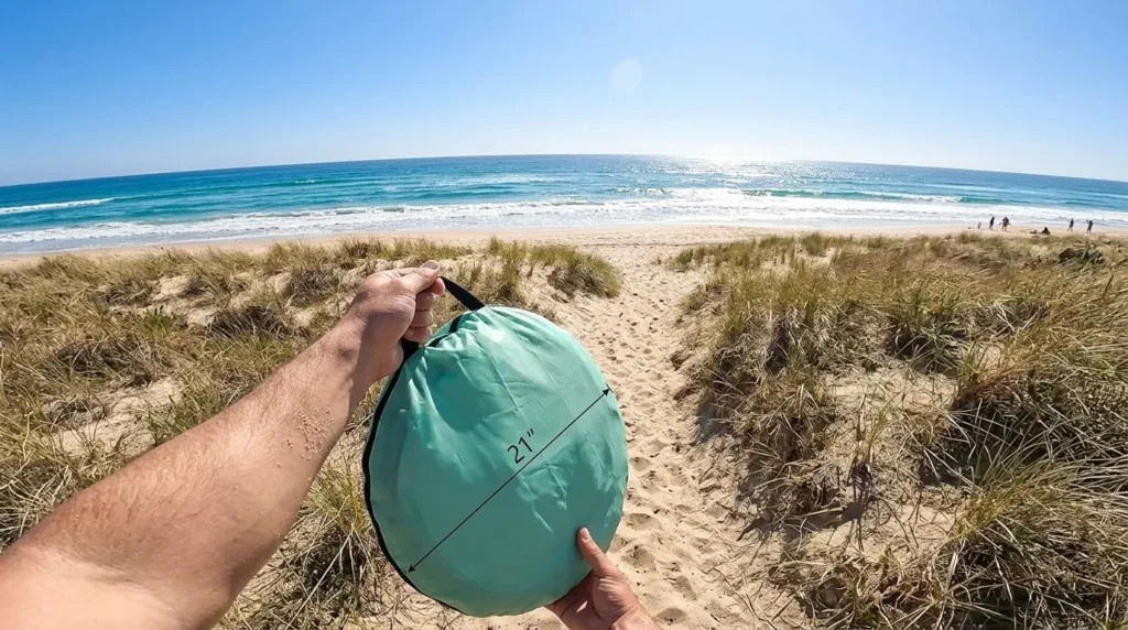 A person showing the compact Sunba Youth baby beach tent bag.