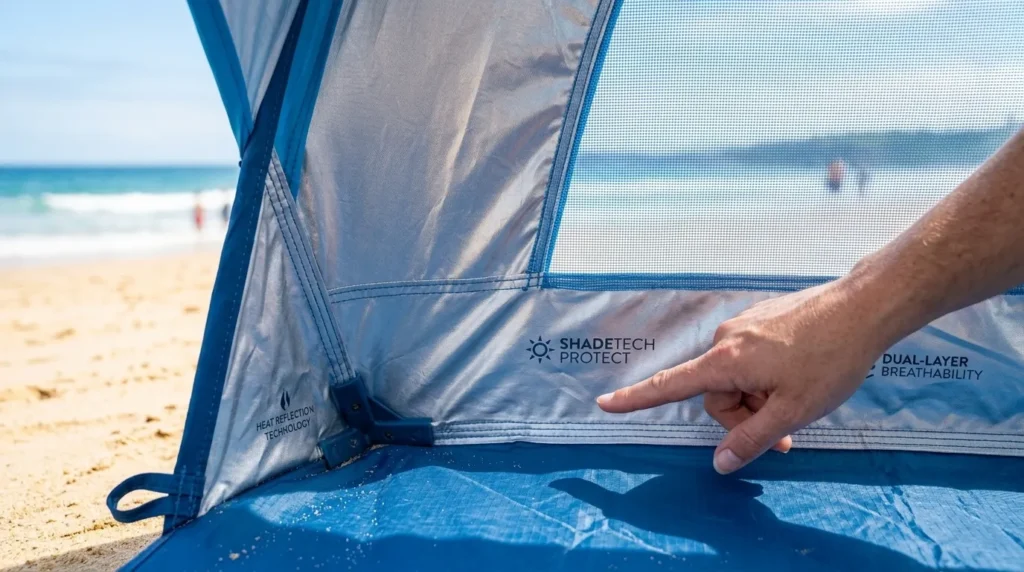 What to bring to the beach with a baby: A close up of the silver UV protection coating inside a technical baby beach tent.