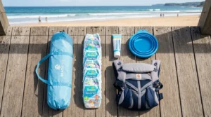 A flat lay photograph of essential baby beach gear and packing items.
