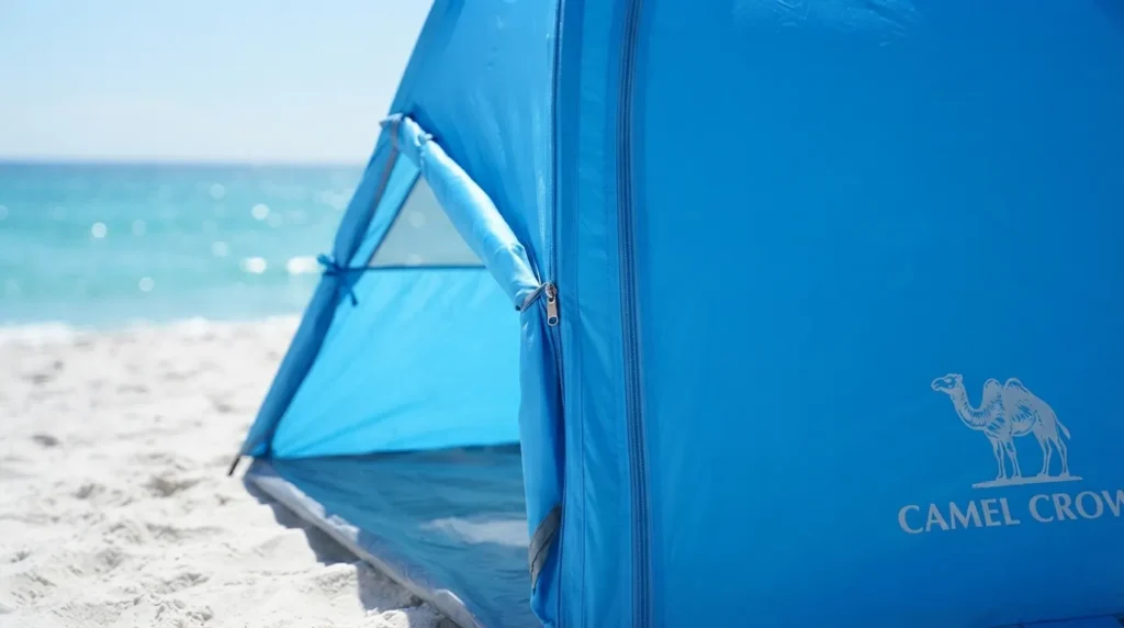 Twin zippered door panels on a Camel Crown beach tent, one open and one closed