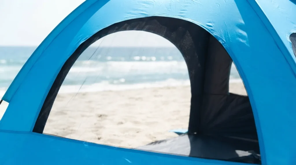 Large mesh window rolled open on NXone beach tent for airflow