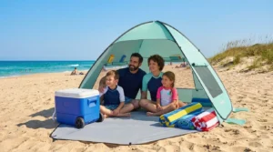 Family of four sitting inside a TOBTOS pop up beach tent on the sand