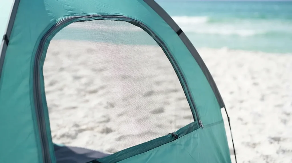 Zippered mesh window open on a beach tent for airflow
