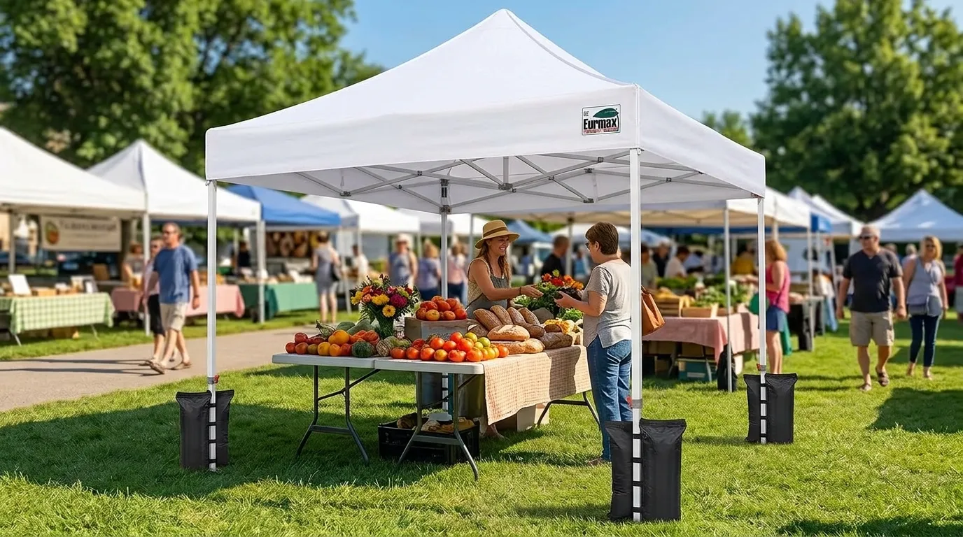 Eurmax USA 10x10 canopy with four weight bags and a no-tip roller bag on a lawn