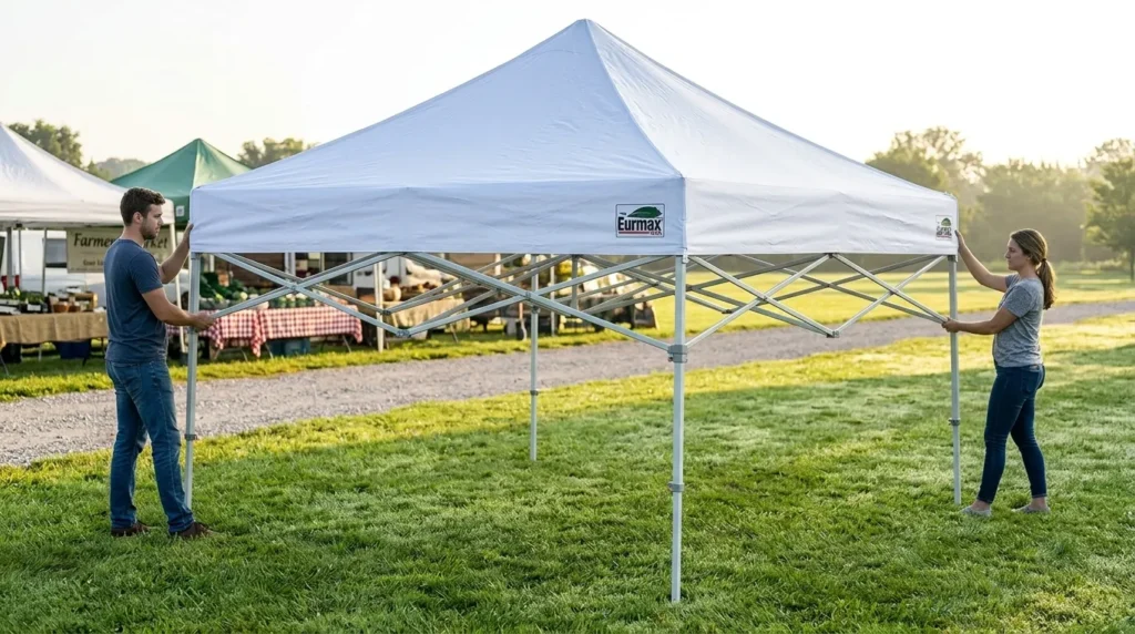 Two people setting up a Eurmax 10x10 canopy by extending the frame