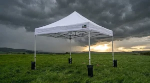 Eurmax USA pop up canopy tent with weight bags under dark storm clouds on a grass field