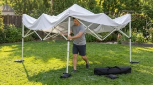 Opening the frame of a Vinabilia pop up canopy tent halfway on a lawn
