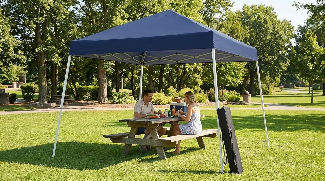Oneofics 10x10 slant leg canopy in navy blue over a picnic table in a park