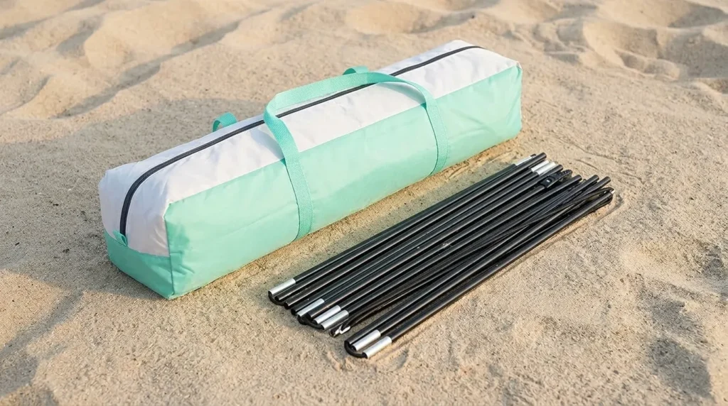 Tent bag and poles laid out for a pop up beach shade tent from Mansader