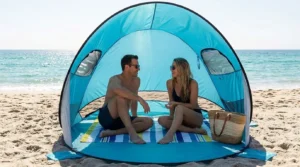 Two adults sitting inside a Wakeman pop up beach tent with both doors open
