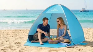 Couple sitting inside a WolfWise pop up beach tent on the sand